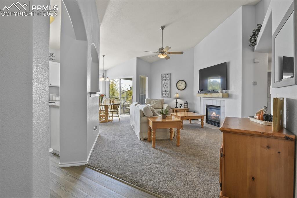 3960 Riviera Grove, Unit 204 Colorado Springs, CO 80922 - Photo 4 of 25 a living room with furniture a fireplace and a flat screen tv