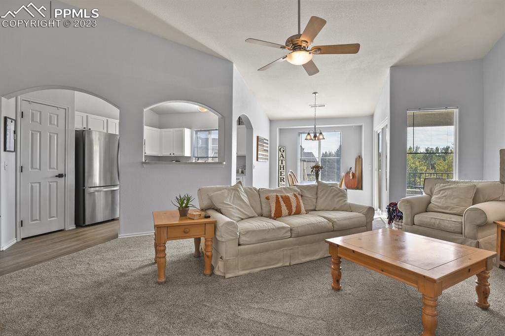 3960 Riviera Grove, Unit 204 Colorado Springs, CO 80922 - Photo 5 of 25 a living room with furniture a ceiling fan and a window