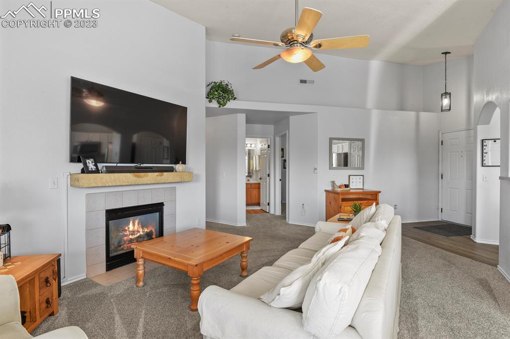 3960 Riviera Grove, Unit 204 Colorado Springs, CO 80922 - Photo 7 of 25 a living room with furniture a flat screen tv and a fireplace