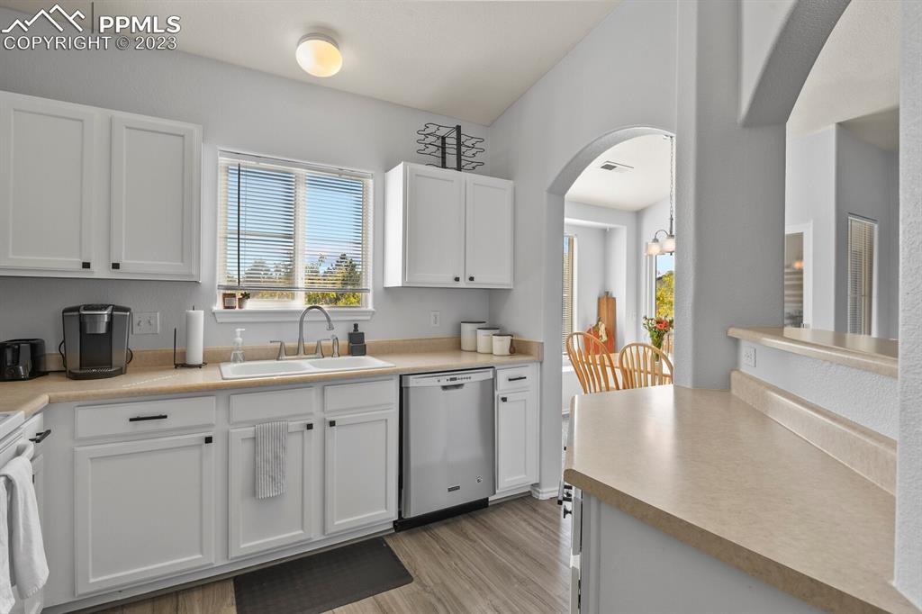 3960 Riviera Grove, Unit 204 Colorado Springs, CO 80922 - Photo 8 of 25 a kitchen with sink cabinets and wooden floor
