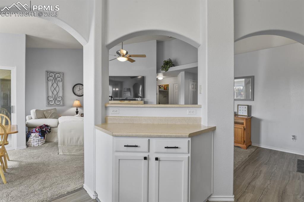 3960 Riviera Grove, Unit 204 Colorado Springs, CO 80922 - Photo 9 of 25 a living room with furniture and a wooden floor
