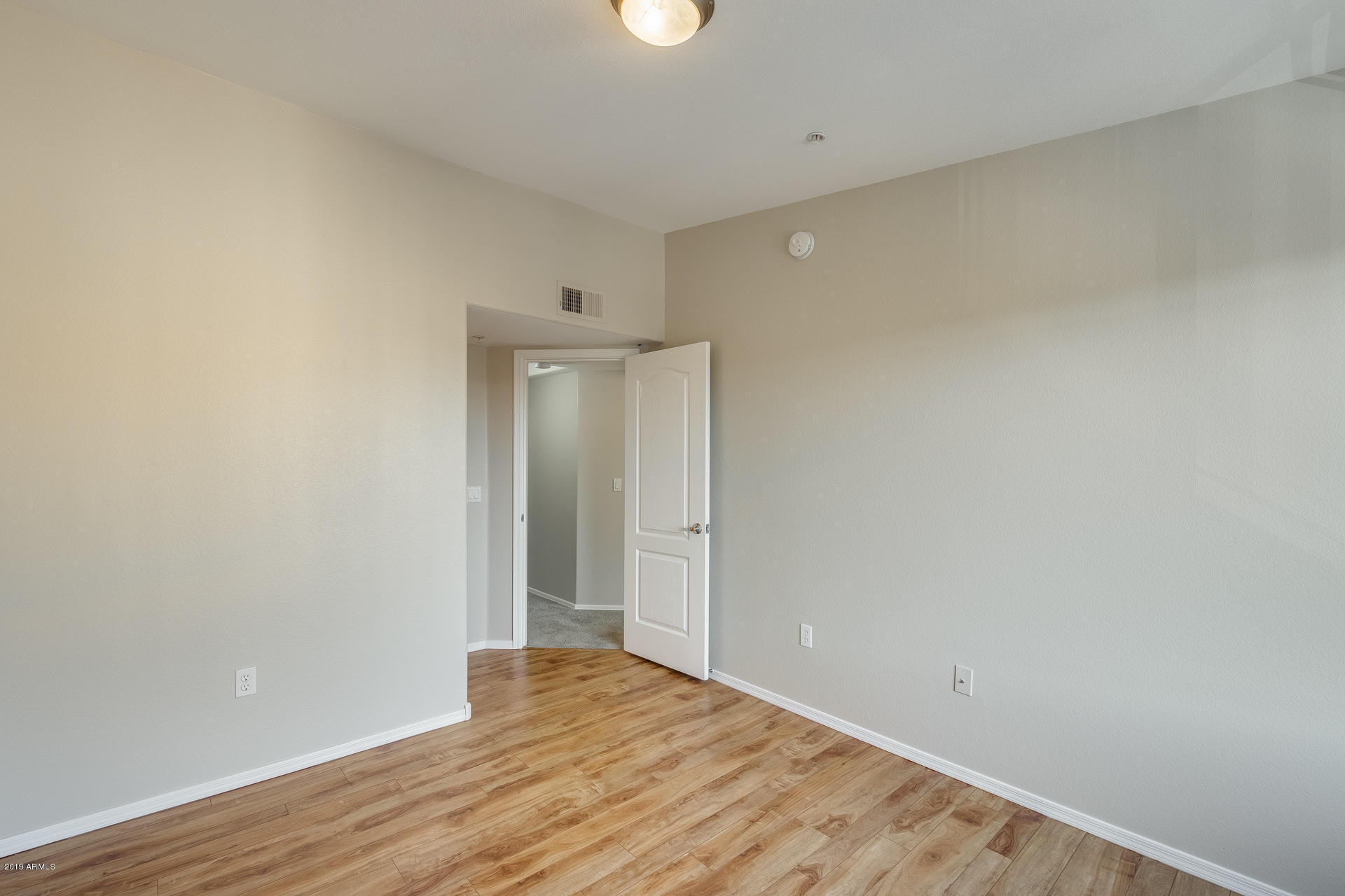 2401 East Rio Salado Parkway, Unit 1124 Tempe, AZ 85288 - Photo 4 of 32 a view of an empty room with wooden floor