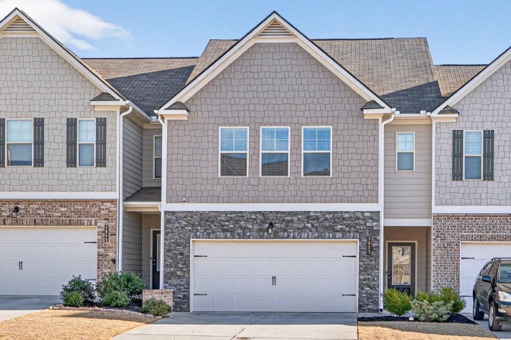 3652 Prospect Point Drive Oakwood, GA 30566 - Photo 1 of 20 a front view of a house with a yard and garage