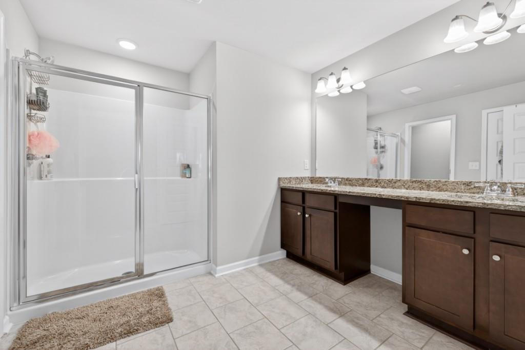 3652 Prospect Point Drive Oakwood, GA 30566 - Photo 16 of 20 a bathroom with a granite countertop sink a mirror and a shower