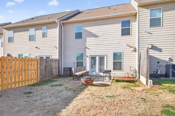 a view of a house with backyard and sitting area