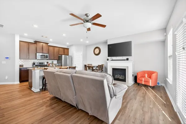 a living room with furniture a fireplace and a flat screen tv
