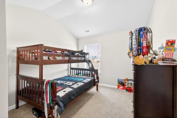 a bedroom with furniture a baby crib and a wooden floor