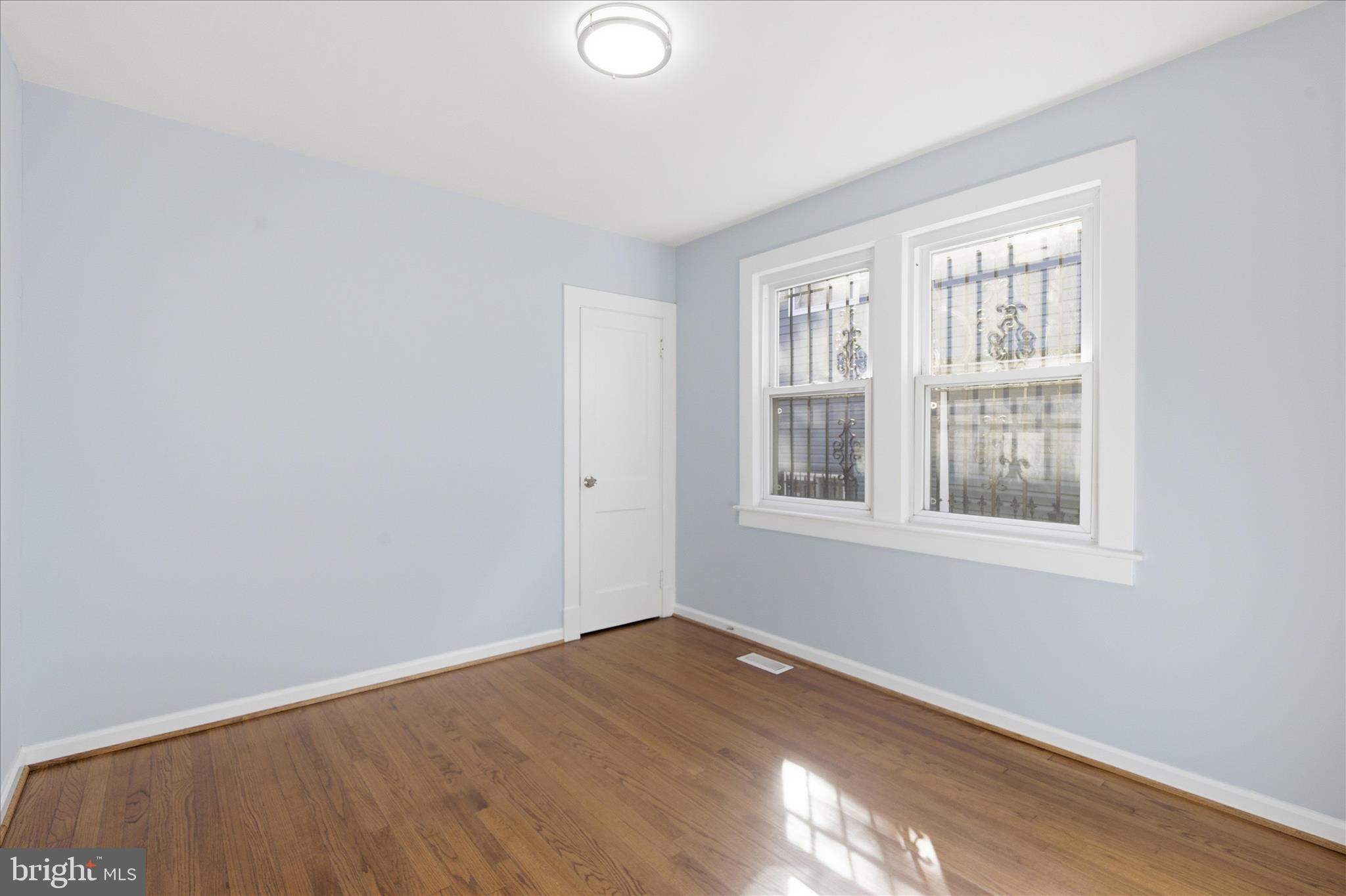 4029 Gault Place Northeast Washington, DC 20019 - Photo 14 of 33 a view of an empty room with wooden floor and a window
