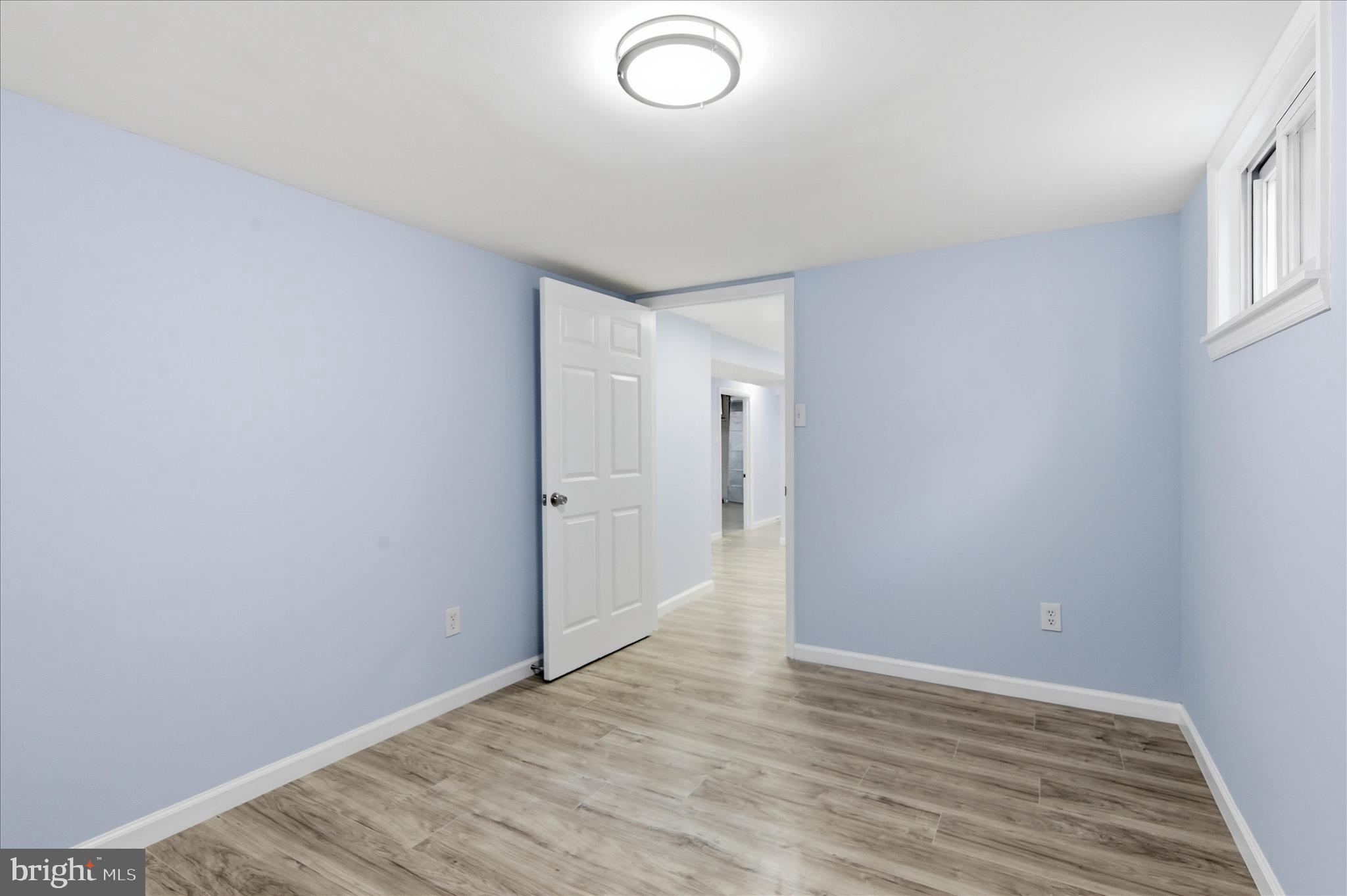 4029 Gault Place Northeast Washington, DC 20019 - Photo 22 of 33 a view of an empty room with wooden floor and a window