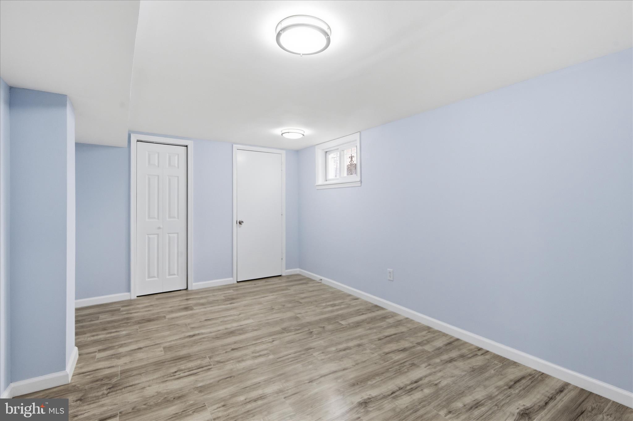 4029 Gault Place Northeast Washington, DC 20019 - Photo 23 of 33 an empty room with wooden floor and windows