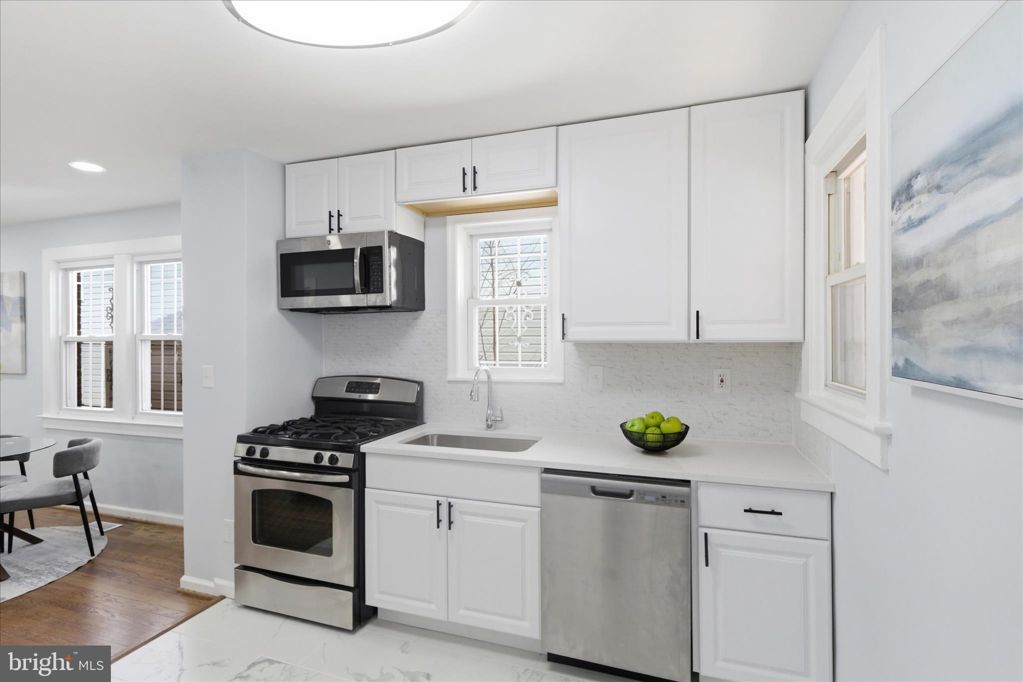 4029 Gault Place Northeast Washington, DC 20019 - Photo 9 of 33 a kitchen with a stove a sink and a microwave