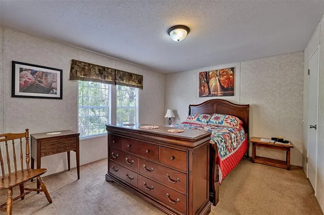 a bedroom with a bed and a desk