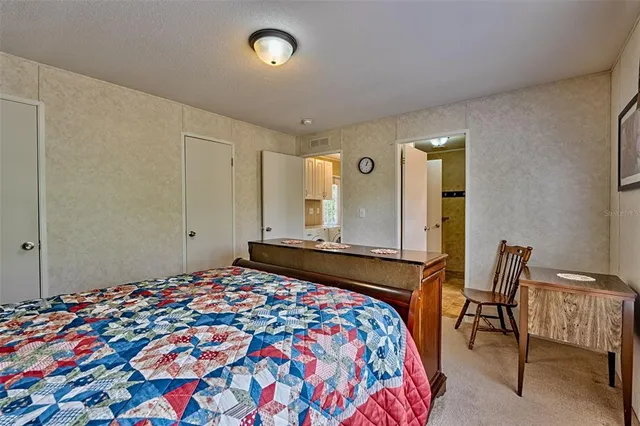 a bedroom with a bed and chair