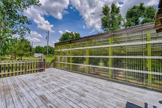 a view of a wooden deck with a big yard