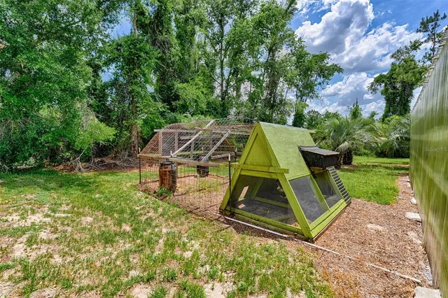 a backyard of a house with table and chairs
