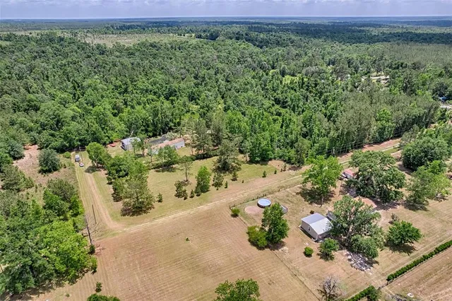 an aerial view of a houses with a yard