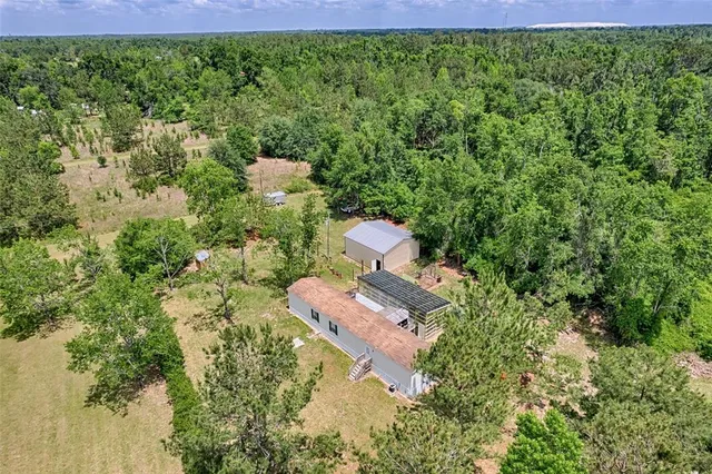 an aerial view of a house with a lake view