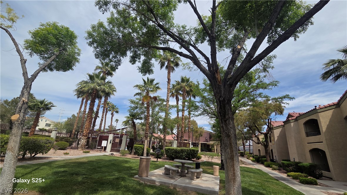 7885 West Flamingo Road, Unit 1008 Las Vegas, NV 89147 - Photo 27 of 29 A tranquil green space with mature trees and a picnic area offers a serene escape.
