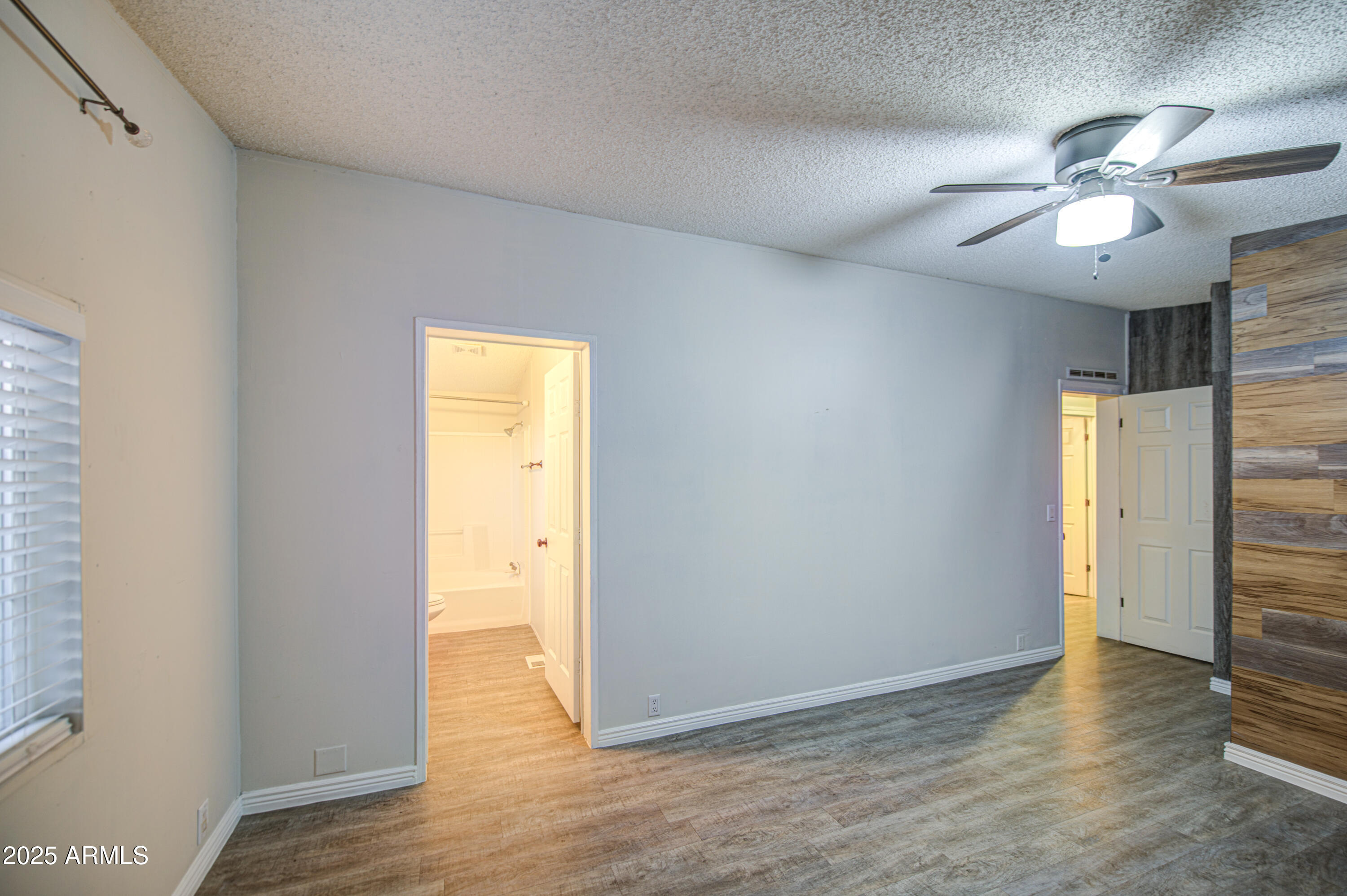19401 North 7th Street, Unit 94 Phoenix, AZ 85024 - Photo 12 of 12 a view of an empty room and wooden floor
