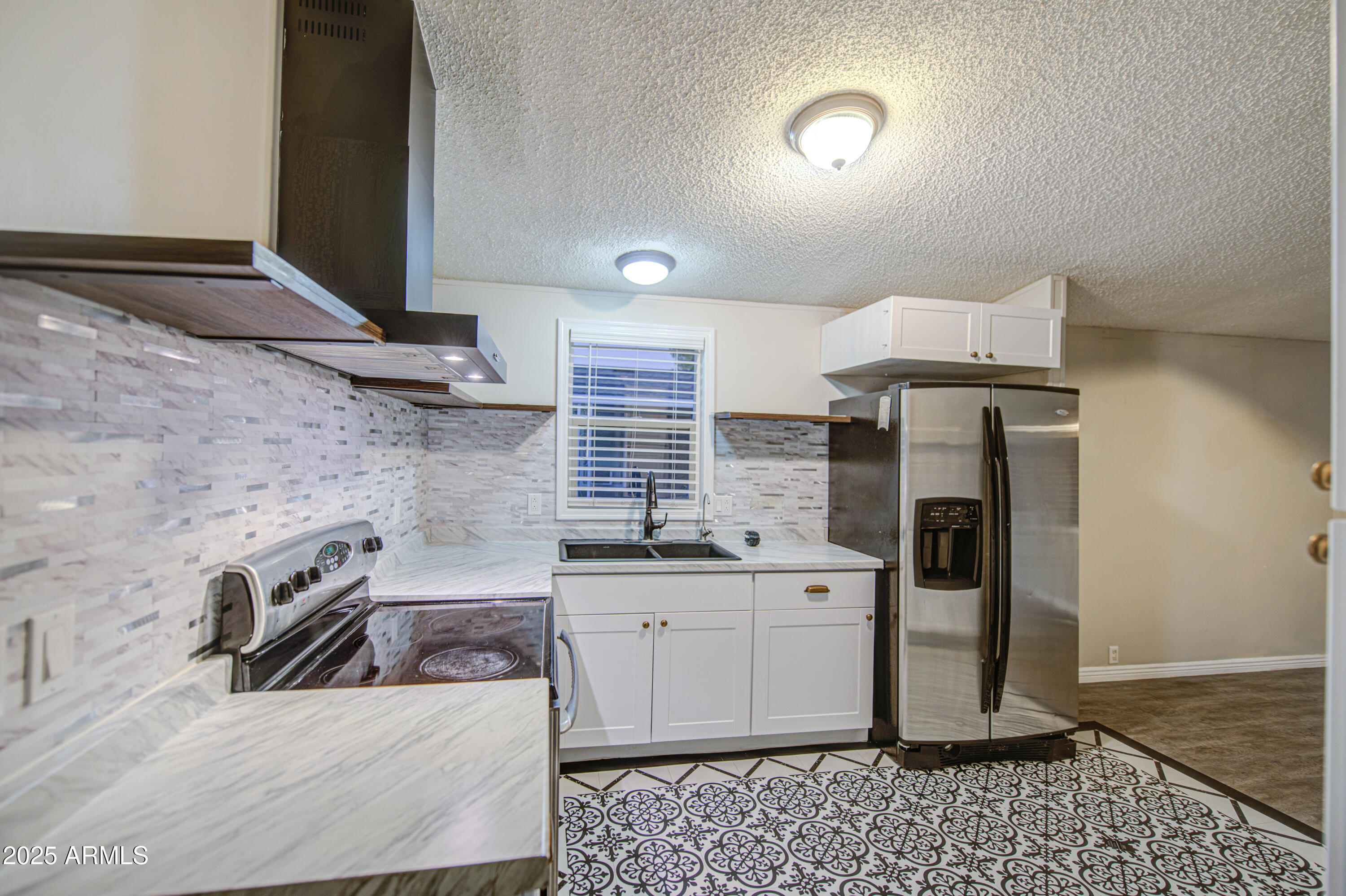 19401 North 7th Street, Unit 94 Phoenix, AZ 85024 - Photo 6 of 12 a kitchen with stainless steel appliances granite countertop a sink stove and refrigerator