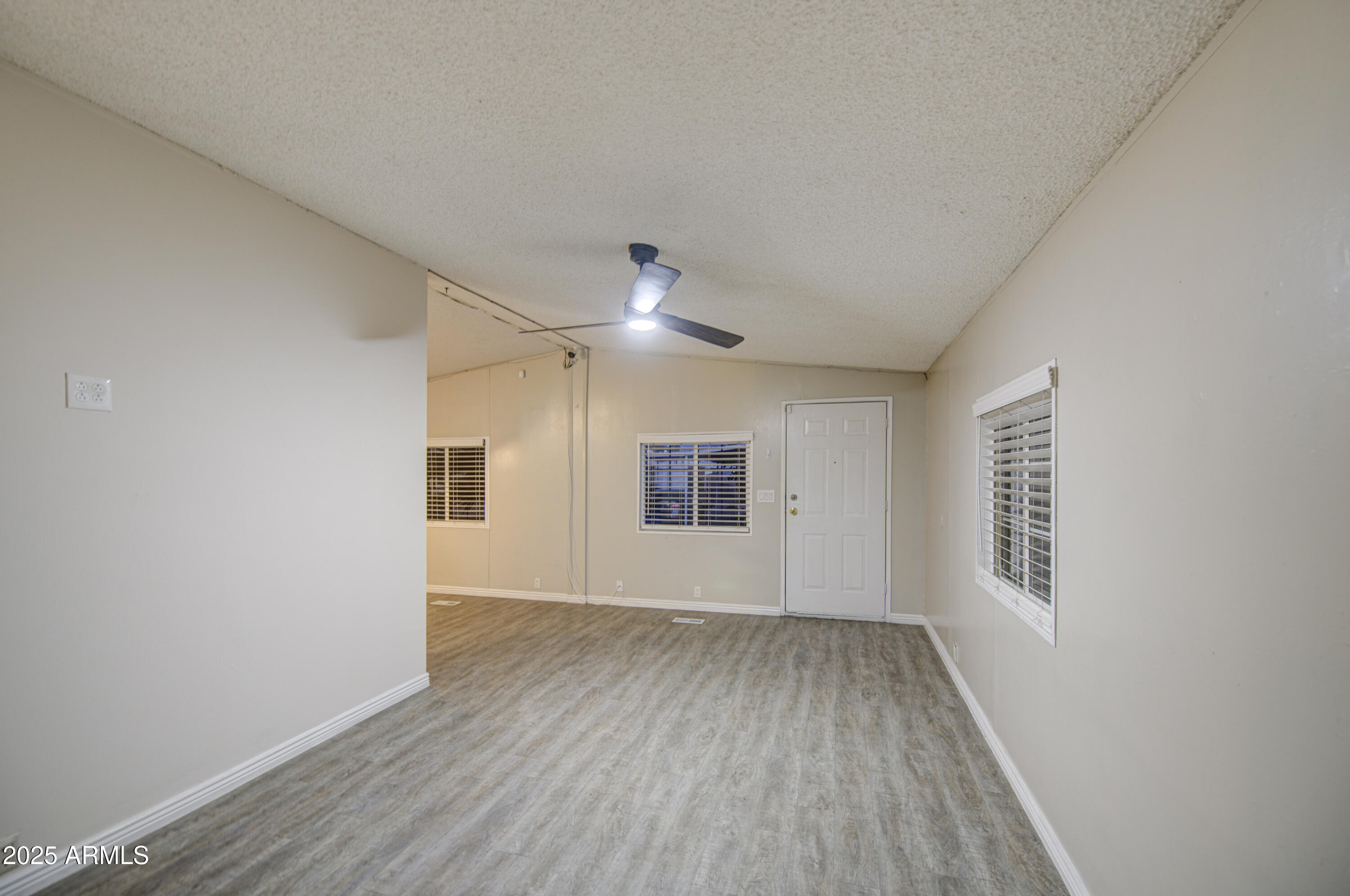 19401 North 7th Street, Unit 94 Phoenix, AZ 85024 - Photo 10 of 12 wooden floor in an empty room with a window