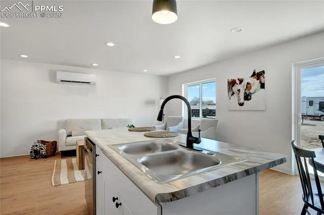 a kitchen with a sink and a stove top oven