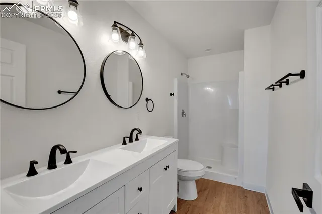 a bathroom with a toilet a sink and a mirror