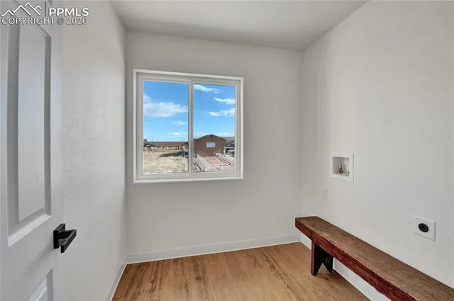a view of room with a window and wooden floor