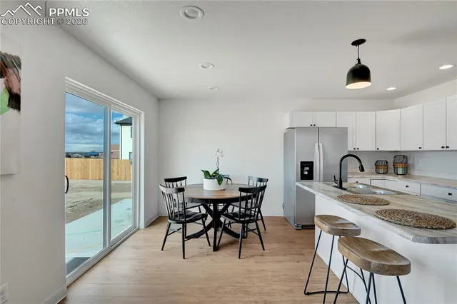 a view of a dining room with furniture window and outside view