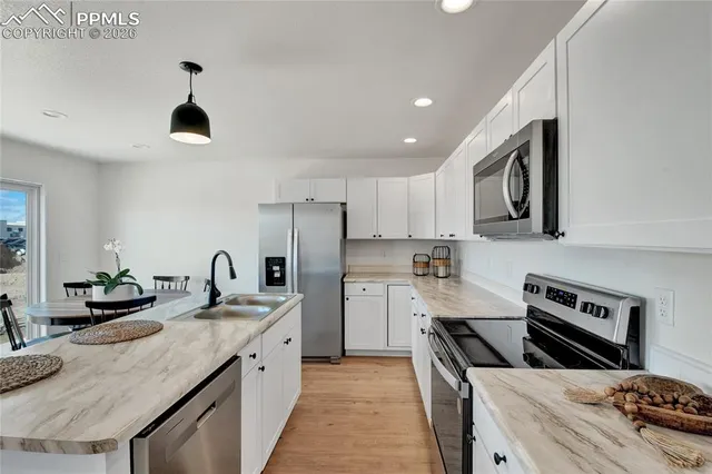 a kitchen with a sink stove and refrigerator