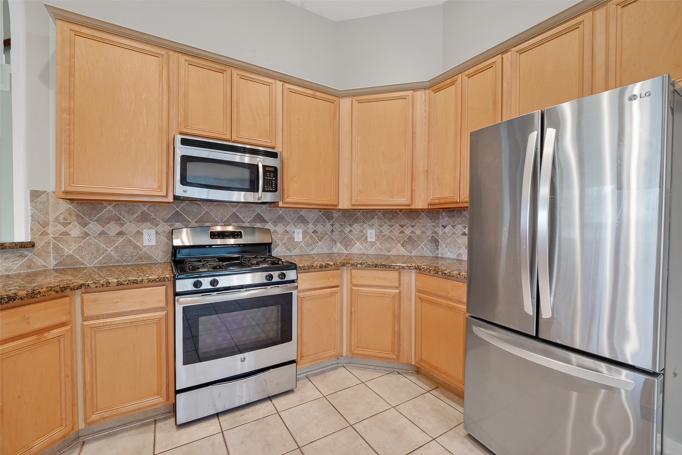 14308 Rocky Briar Lane Rosharon, TX 77583 - Photo 15 of 46 a kitchen with granite countertop cabinets stainless steel appliances and a counter space