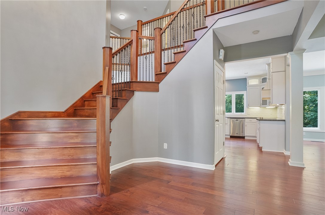 1453 Prospect Road Hudson, OH 44236 - Photo 3 of 50 Staircase featuring wood finished floors, healthy amount of natural light, and a towering ceiling