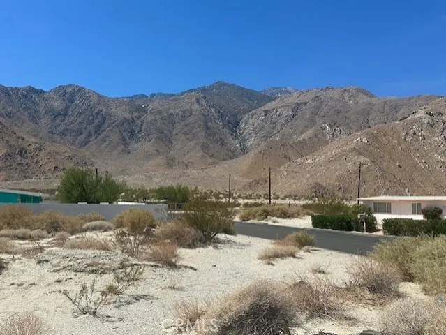 a view of a road with mountains in the background