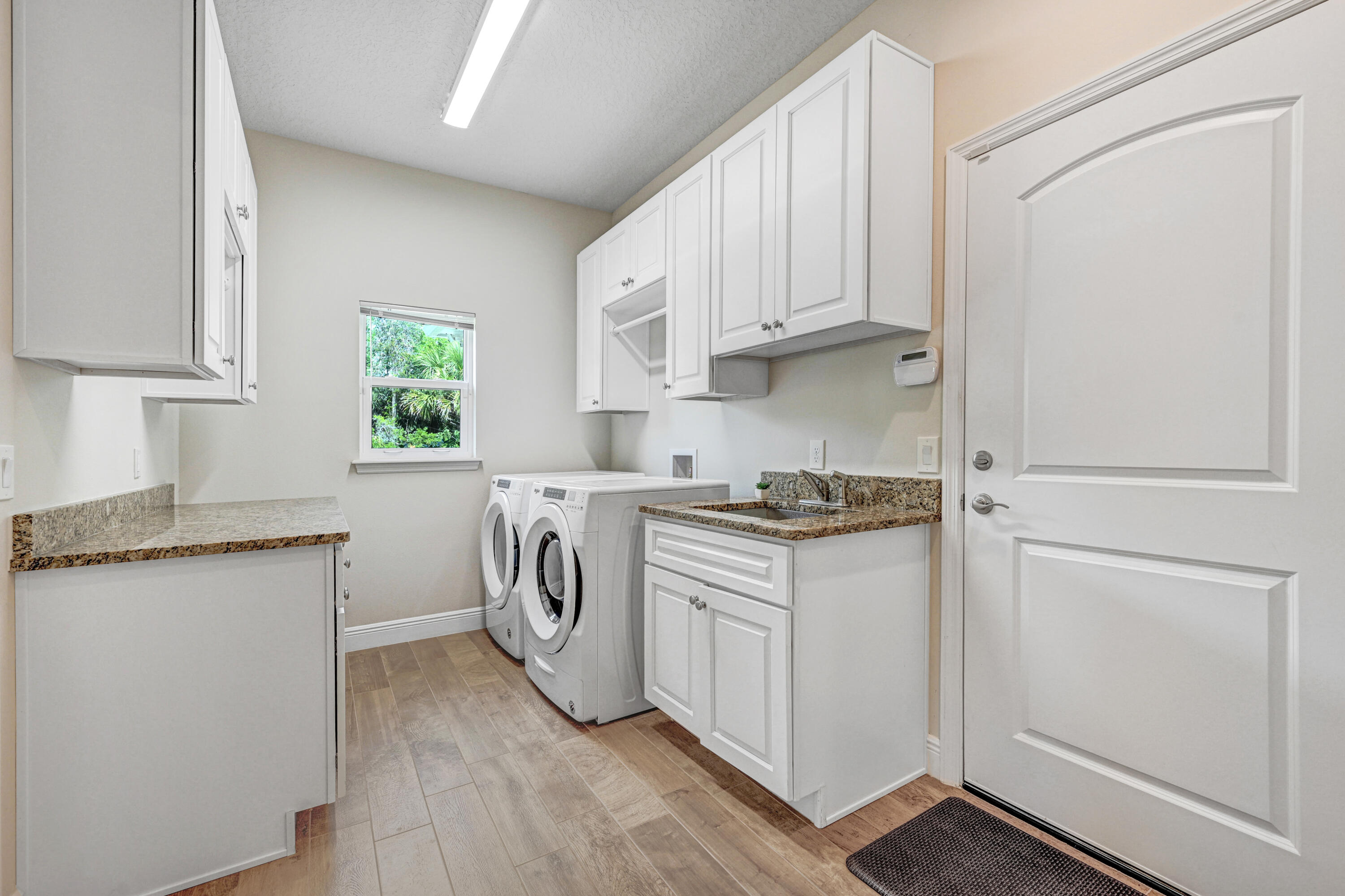 2690 Weber Road Malabar, FL 32950 - Photo 34 of 60 a kitchen with white cabinets and a stove