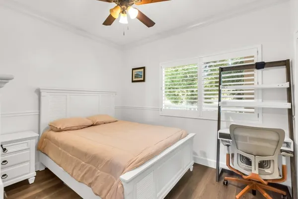 a kitchen with kitchen island granite countertop a refrigerator a stove a sink dishwasher a dining table and chairs with wooden floor