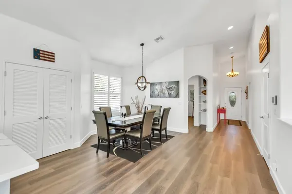a kitchen with a refrigerator cabinets and wooden floor