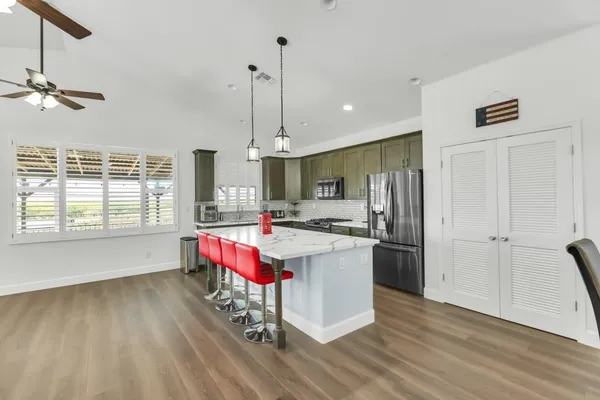 a kitchen with a sink stove top oven and cabinets
