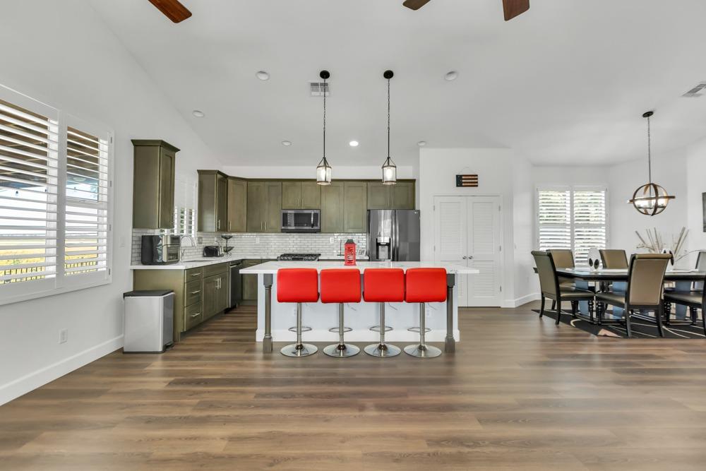 32852 South River Road Clarksburg, CA 95612 - Photo 16 of 72 a living room with stainless steel appliances kitchen island granite countertop furniture and a wooden floor
