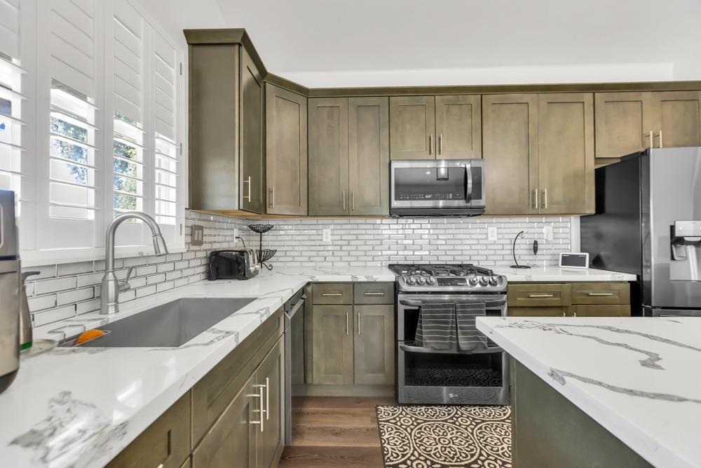 32852 South River Road Clarksburg, CA 95612 - Photo 18 of 72 a kitchen with a sink stove top oven and cabinets