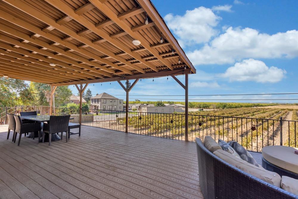 32852 South River Road Clarksburg, CA 95612 - Photo 50 of 72 a view of a roof deck with dining table and chairs with wooden floor