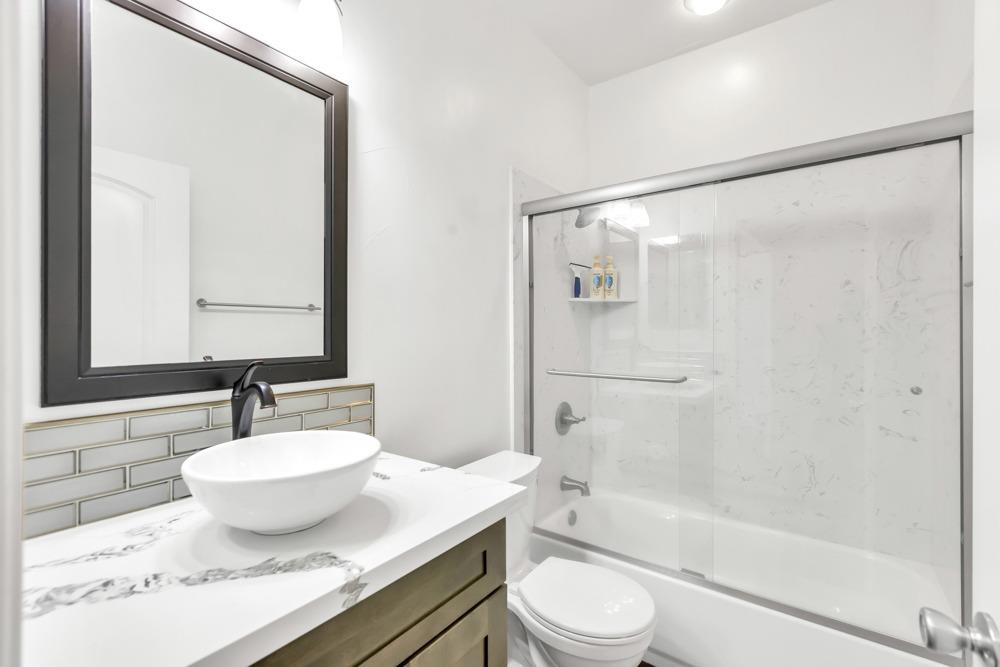 32852 South River Road Clarksburg, CA 95612 - Photo 9 of 72 a bathroom with a granite countertop sink toilet and shower