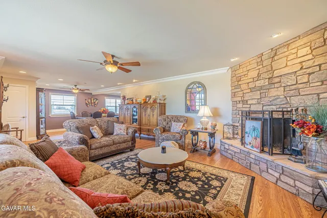 a dining room with furniture a chandelier and wooden floor