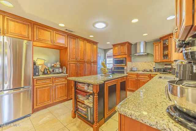 a dining room with wooden floor and large windows
