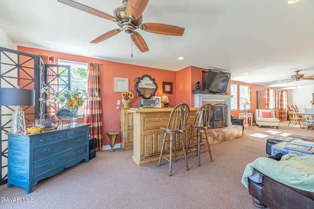 a bed room with a bed a flat screen tv and a dresser