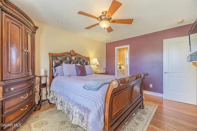 a bed room with a bed and a chair