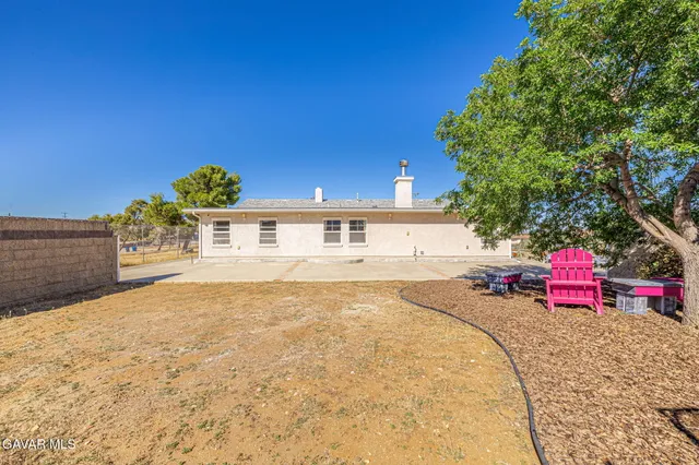 a swimming pool with outdoor seating and yard