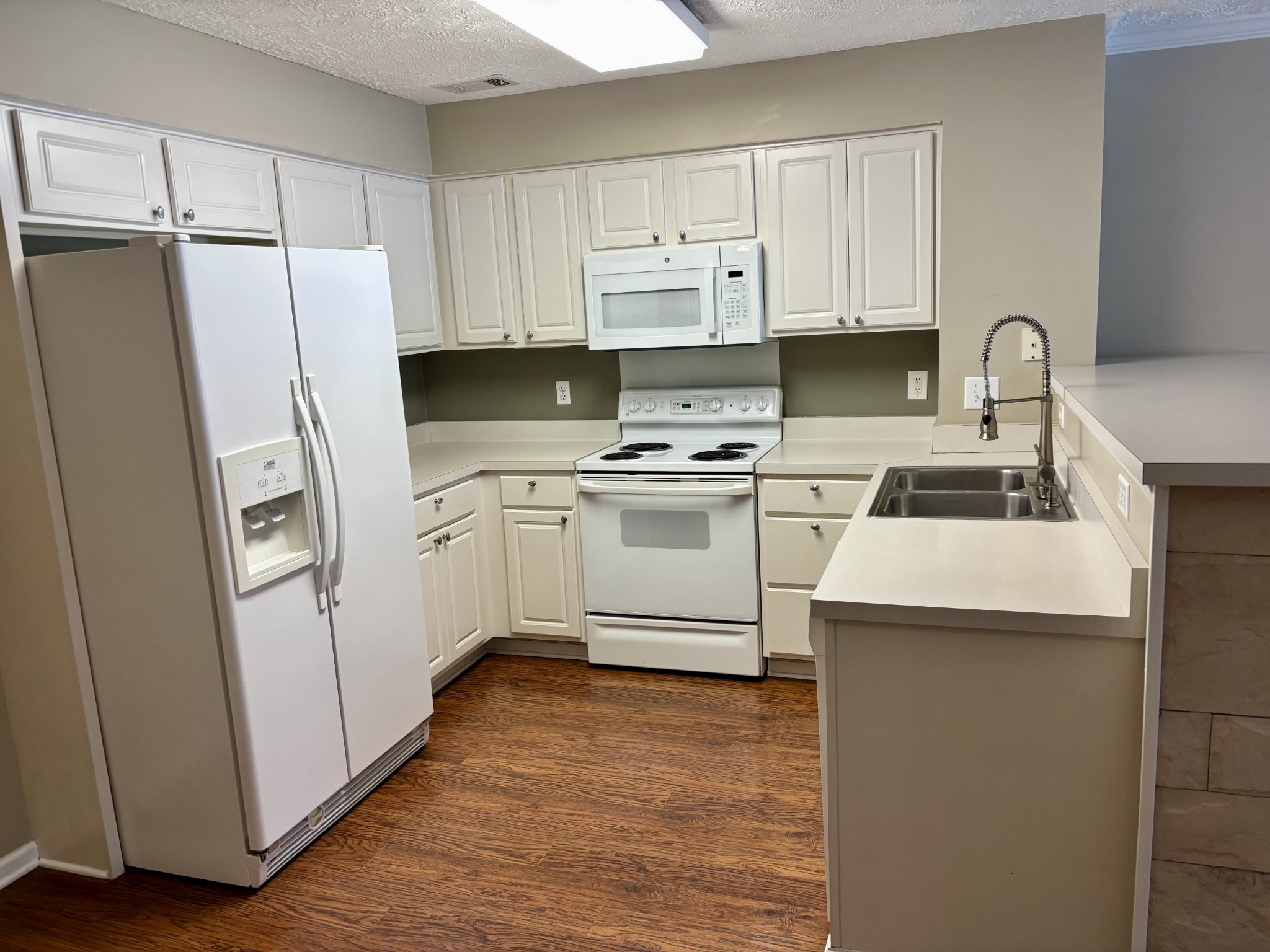 409 Compton Lane Franklin, TN 37069 - Photo 5 of 23 a kitchen with a sink a refrigerator a washer and dryer