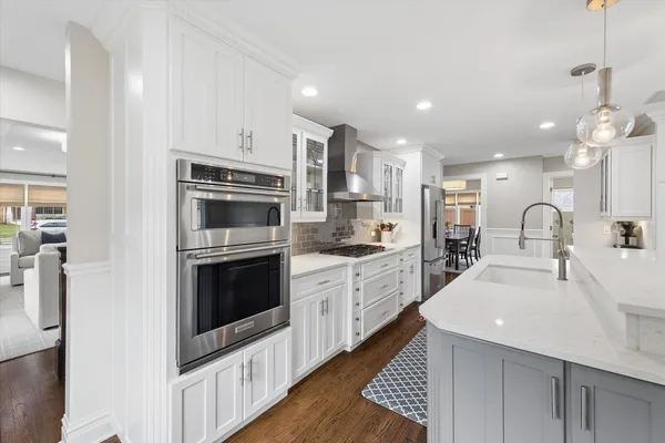 a kitchen with stainless steel appliances kitchen island granite countertop a sink and a stove
