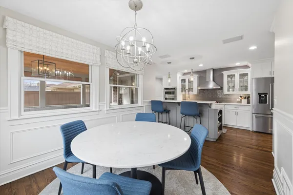 a view of a dining room with furniture wooden floor and chandelier