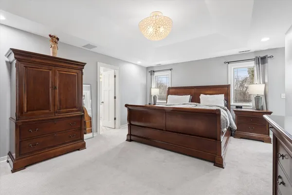 a bedroom with a bed and a chandelier